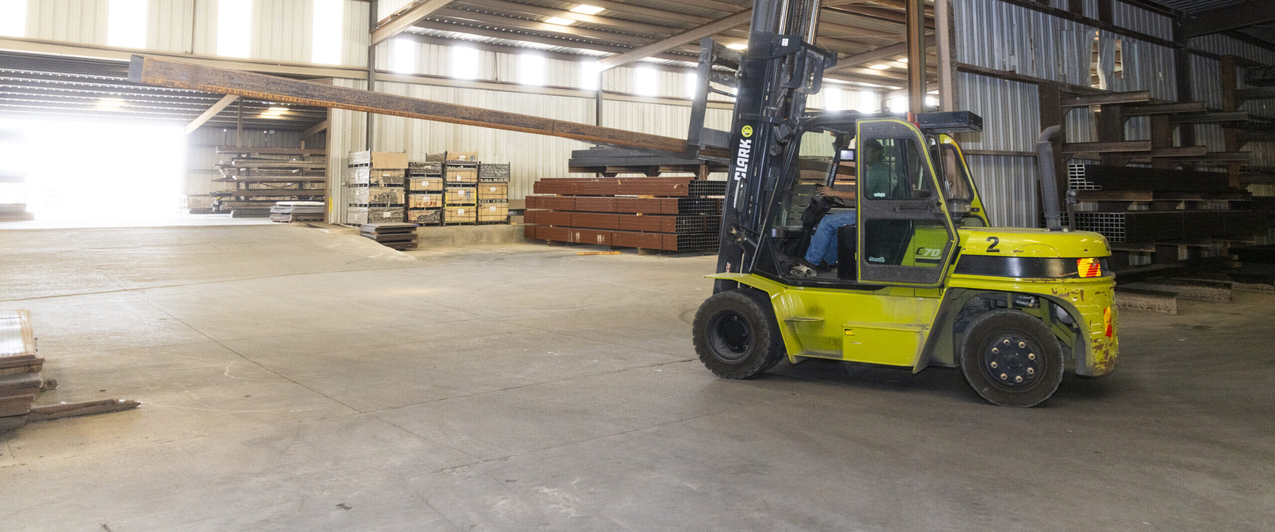 A man driving a forklift at Eagle National Steel